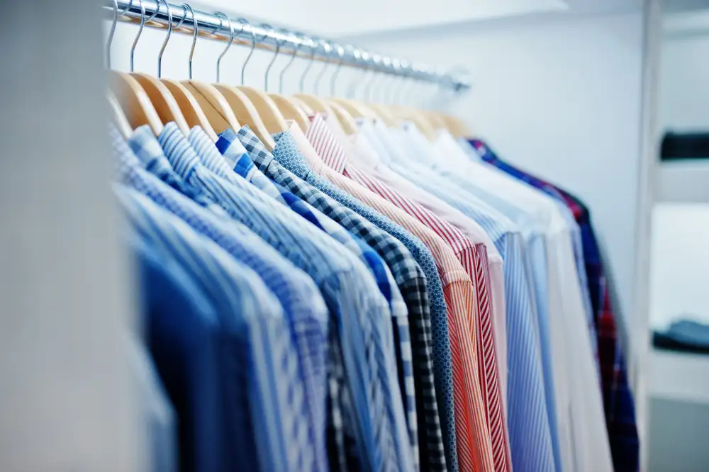Freshly washed shirts on hangers after laundry with P&G detergent and fabric conditioner