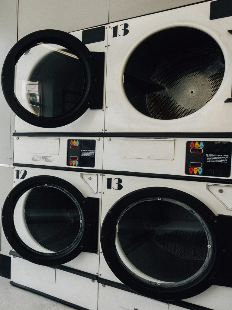 Stacked commercial dryers in a self-service laundromat